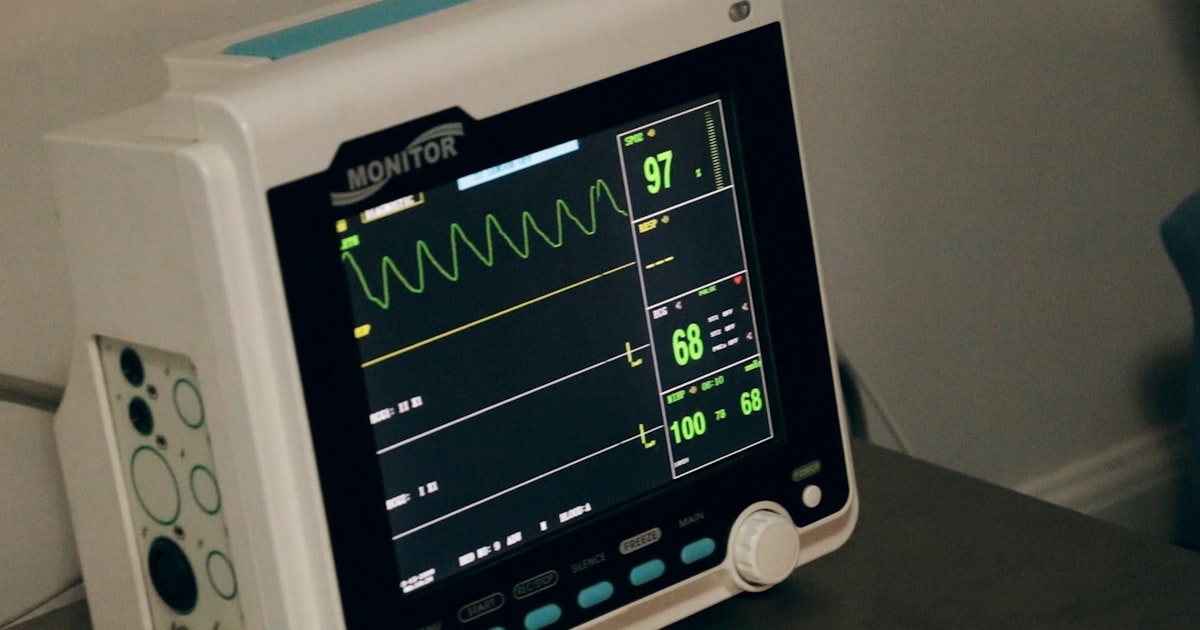 Medical monitor displaying patient vital signs in a clinical setting
