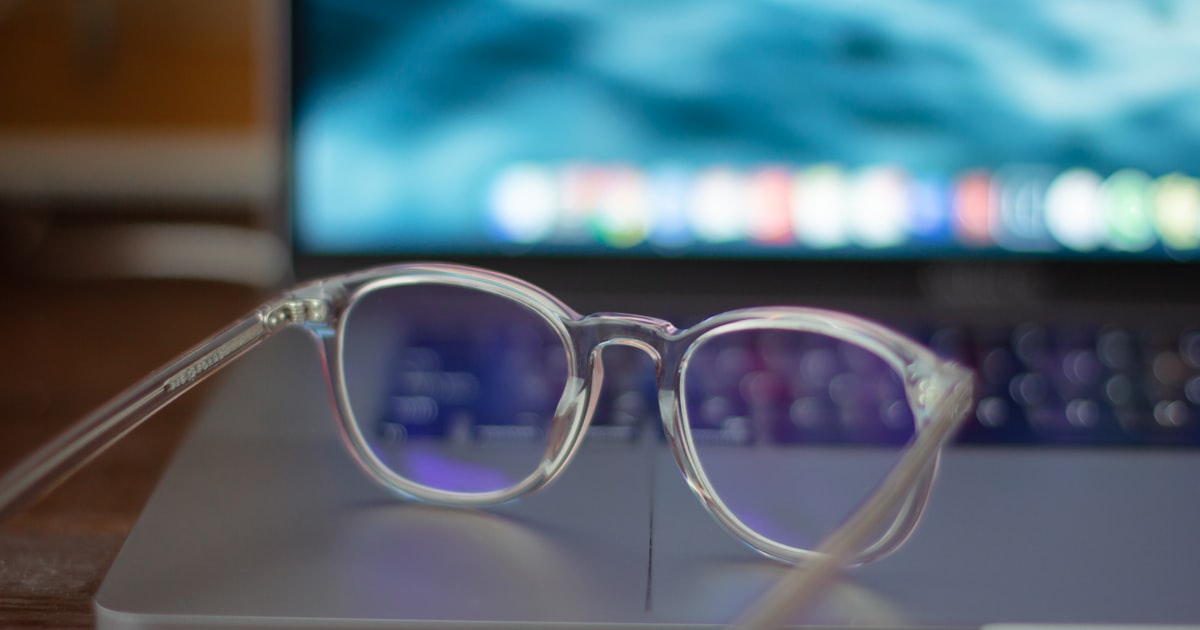 Silver framed eyeglasses resting on a white table