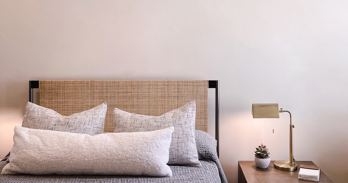 Cozy bedroom with nightstand and lamp at night